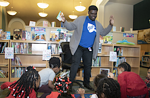 **FILE** Branden Mitchell reads an interactive story to students during library time at Wheatley Education Campus in northeast D.C. (Shevry Lassiter/The Washington Informer)