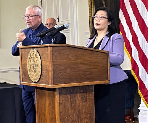 Maryland Deputy Health Secretary Dr. Jinlene Chan lays out the state plan for administering coronavirus vaccines to children ages 5 to 11 once they are eligible during an Oct. 25 press briefing at the State House in Annapolis as Gov. Larry Hogan (rear left) listens. (William J. Ford/The Washington Informer)