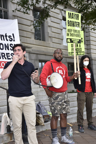 Michael Marinelli (left) speaks during a rally calling for the extension of the STAY DC program, designed to help District residents adversely affected by the coronavirus pandemic with rental and utility assistance, at the John A. Wilson Building on Oct. 24. (Robert R. Roberts/The Washington Informer)
