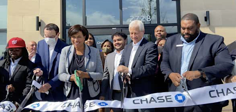 D.C. Mayor Muriel Bowser with JP Morgan Chase President and CEO Jamie Dimon cut the ribbon of the new Chase Banking Center at its official grand opening at Skyland Town Center in Southeast. (DR Barnes/The Washington Informer)