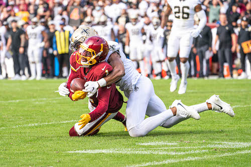 Washington Football Team wide receiver DeAndre Carter is tackled during a 33-22 loss to the New Orleans Saints at FedEx Field in Landover, Md., on Oct. 10. (Abdullah Konte/ The Washington Informer)