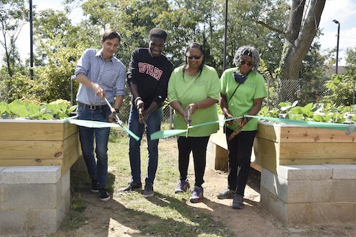 From left: Scott Kratz, vice president of Building Bridges Across the River Engineers Without Borders – USA; Cheikh Badiane, Howard University engineering student; Leslie Haywood; and Velma Speight, director, Allen Chapel AME Church, McKinley Crudum Outreach Center, participate in a Sept. 30 ribbon-cutting ceremony for the Center’s newly expanded urban farm. (Robert R. Roberts/ The Washington Informer)