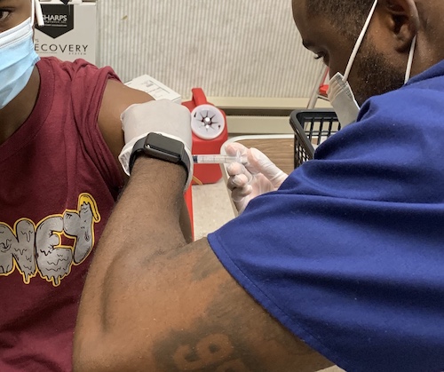 **FILE** A school-aged young man receives a COVID-19 vaccination. (WI photo)