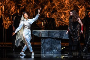 "Iphigenia" is the opera composed by Wayne Shorter and esperanza spalding. The writer of the libretto, also known as lyrics, esperanza spalding, enters the stage as male characters observe. The opera was presented at the John F. Kennedy Center for the Performing Arts in D.C. on Dec. 10 and 11. (Photo courtesy of Jati Lindsay)