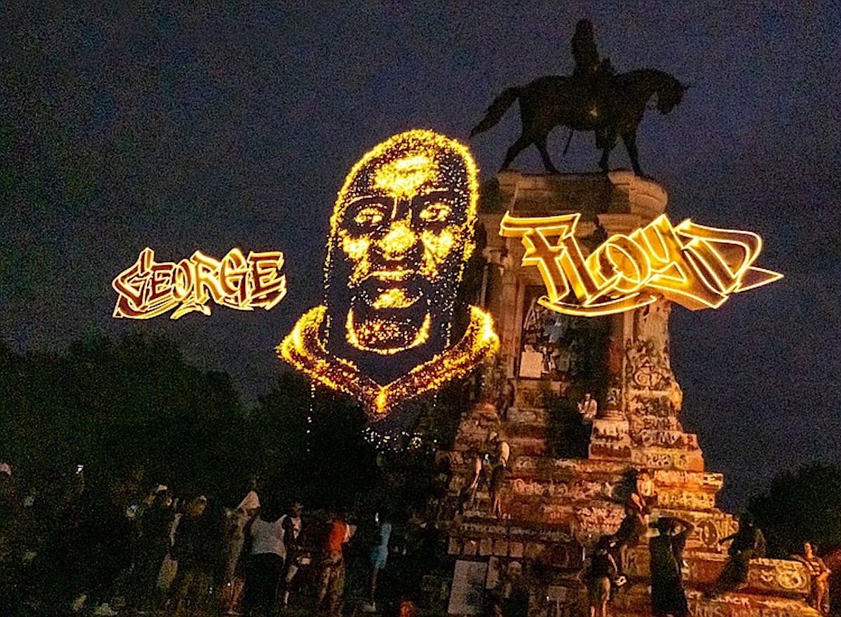 A hologram of the late George Floyd shines at the Robert E. Lee statue on Monument Avenue, where hundreds of people joined Floyd's family for the unveiling. the memorial project, sponsored by Change.org and the George Floyd Foundation, will be on display in Richmond through Aug. 6, 2020. (Sandra Sellars/Richmond Free Press via Trice Edney News Wire)