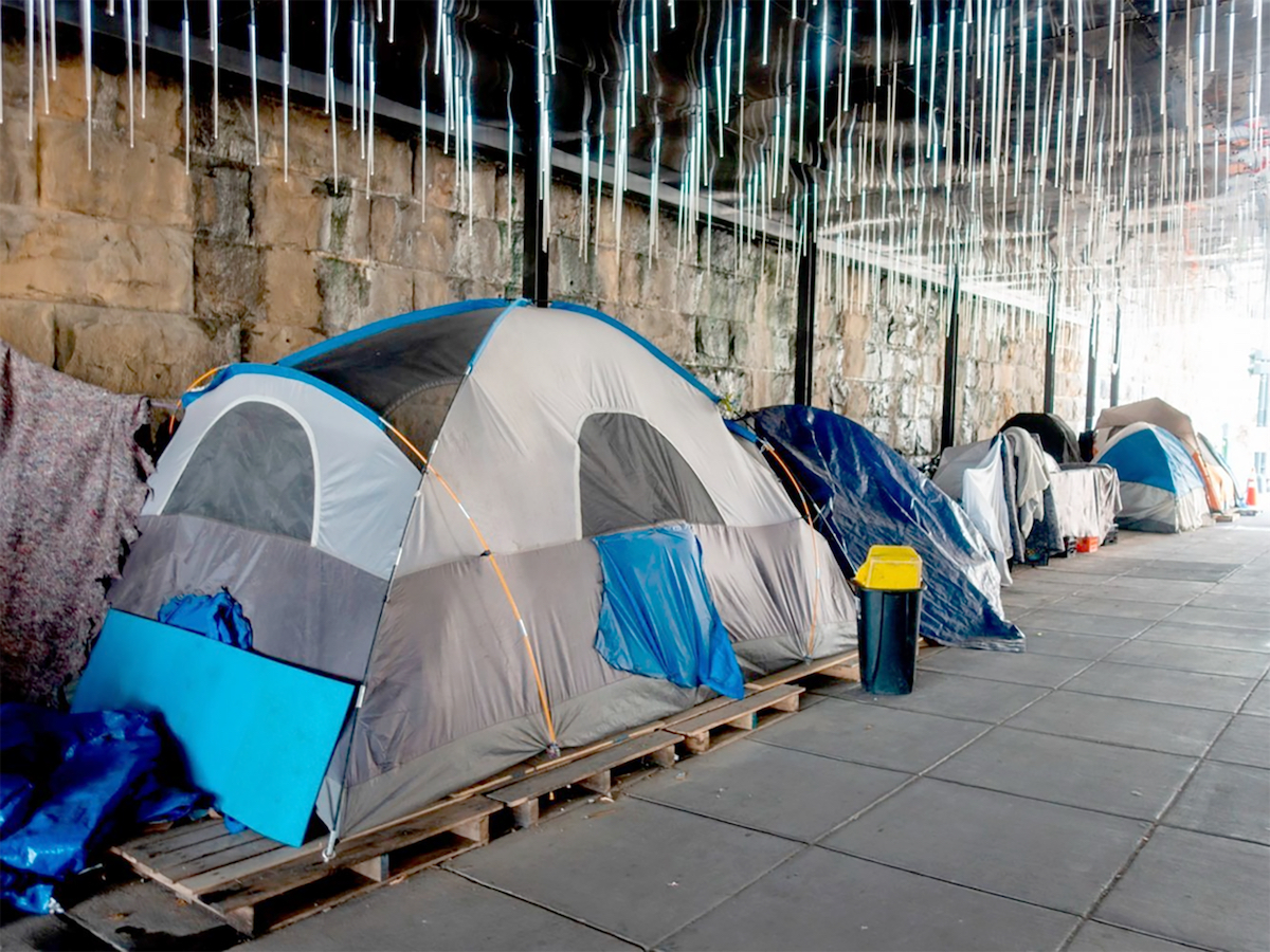 Homeless persons find shelter under a D.C. bridge. (Anthony Tilghman/The Washington Informer)