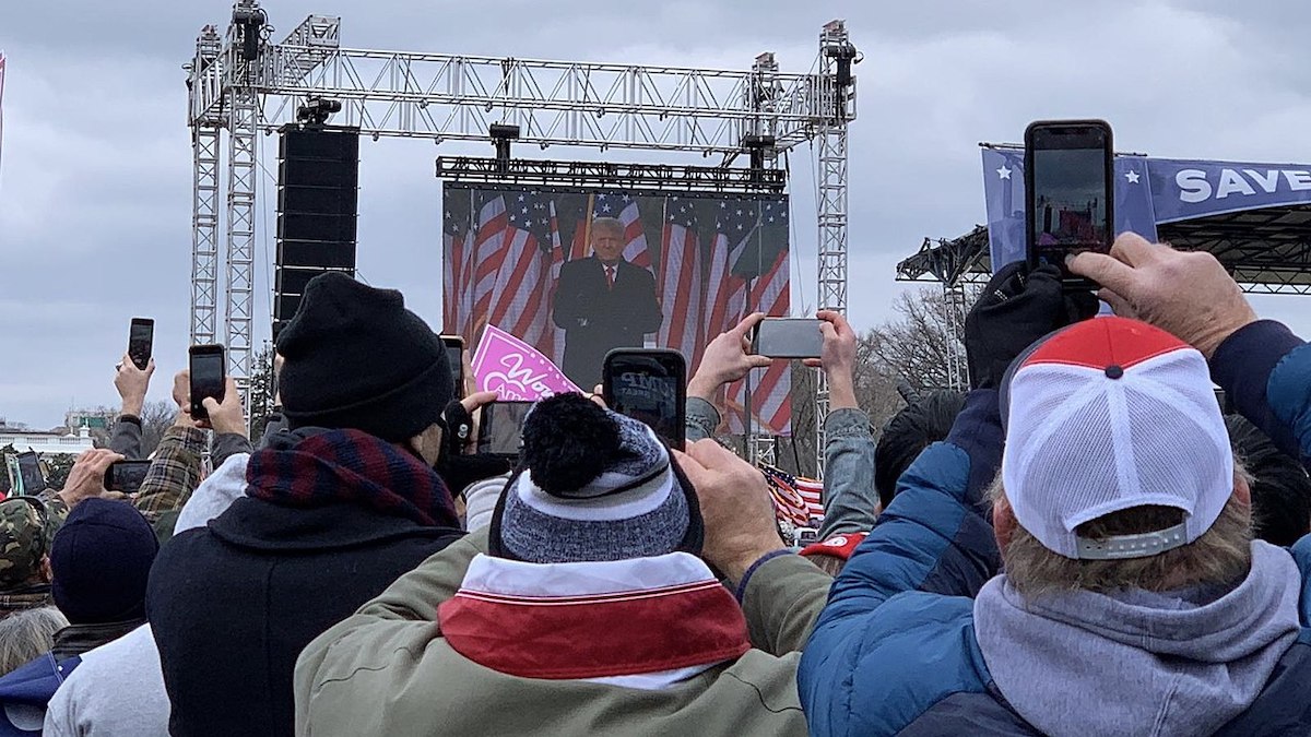 Then-President Trump on a screen at the Jan. 6 rally (Photo by Voice of America)