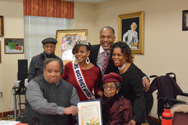 Clockwise from bottom left: Joseph Gilchrist, C.C. Ford, Ms. District of Columbia Vanella Alise Jackson-Crawford, Harry Thomas Jr. and Stacie Mack and Evelyn Spriggs Ford celebrate the 100th birthday of Ford in northeast D.C. on Nov. 30. (Roy Lewis/The Washington Informer)