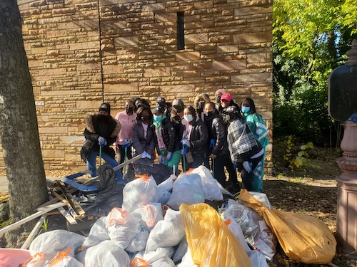 Members of the Gamma Theta chapter of Alpha Kappa Alpha Sorority, Inc. of Hampton University stand behind trash they helped pick up in Ward 8. (James Wright/The Washington Informer)