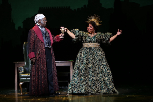Craig Wallace (lef) as Ebenezer Scrooge and Rayanne Gonzales as Spirit of Christmas Present star in the 2021 production of "A Christmas Carol" at Ford's Theatre, directed by José Carrasquillo. The production runs until Dec. 27. (Courtesy of Ford’s Theatre)