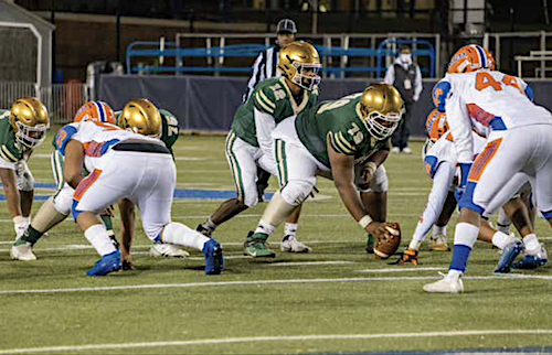 Theodore Roosevelt battles Archbishop Carroll on Dec. 3 at Georgetown University. Archbishop Carroll rallied to defeat Theodore Roosevelt 35-27 in overtime leading to victory as the 2021 DCSAA Class AA Champions. (Ja'Mon Jackson/The Washington Informer)