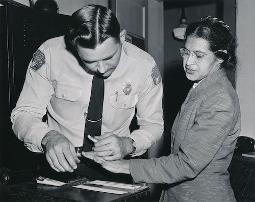 Rosa Parks being fingerprinted on February 22, 1956, by Lieutenant D.H. Lackey as one of the people indicted as leaders of the Montgomery bus boycott. She was one of 73 people rounded up by deputies that day after a grand jury charged 113 African Americans for organizing the boycott. This was a few months after her arrest on December 1, 1955, for refusing to give up her seat to a white passenger on a segregated municipal bus in Montgomery, Alabama. (Wikimedia Commons)