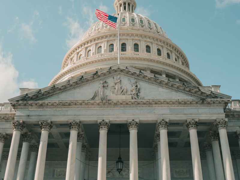 the us capitol building under cloudy blue sky