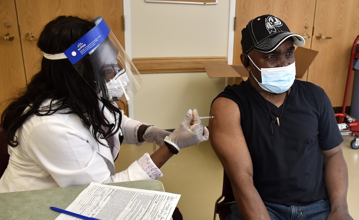 **FILE** James Page receives a dose of the Pfizer coronavirus vaccine at the Bowie Senior Center in Bowie, Maryland, on April 21, 2021. (Robert R. Roberts/The Washington Informer)