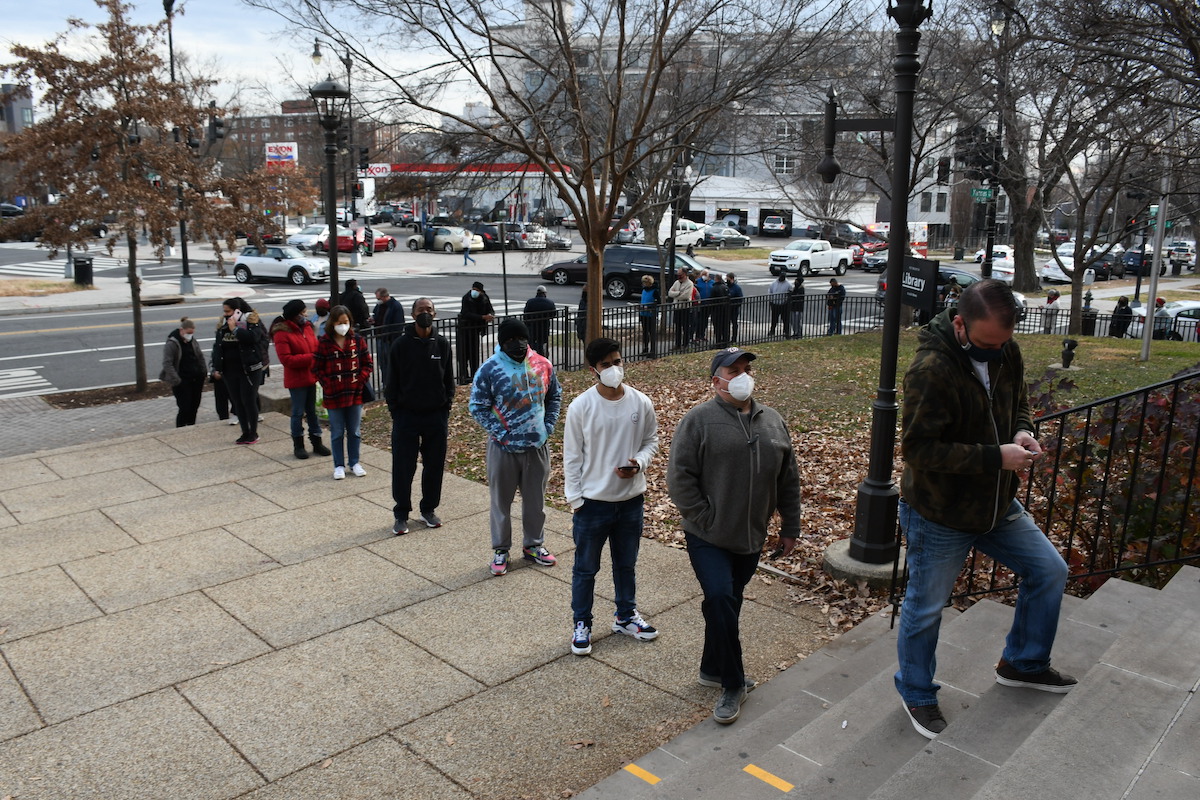 D.C. Public Schools students and teachers line up at Petworth Library in northwest D.C. to receive home test kits for COVID-19. (Roy Lewis/The Washington Informer)