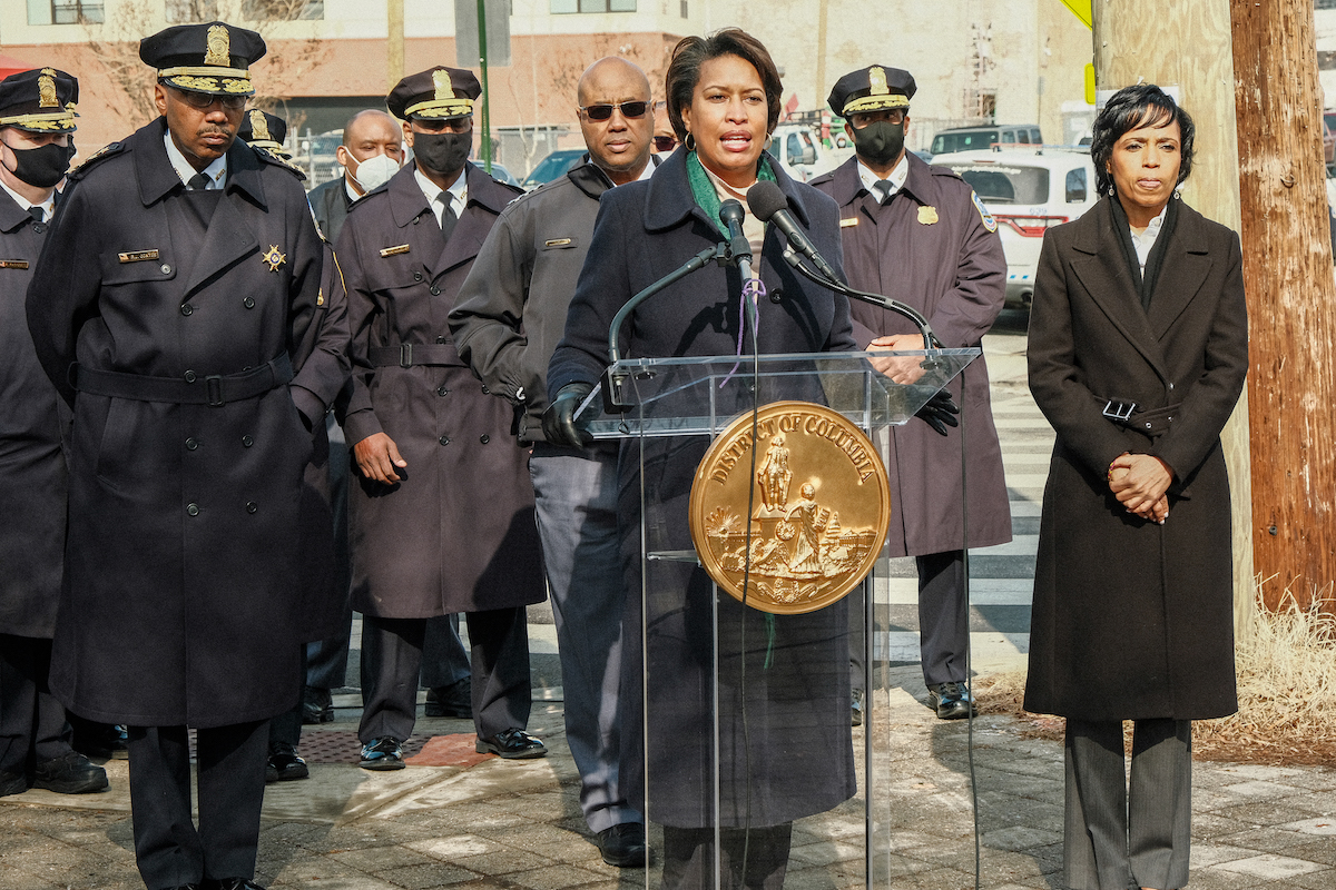 D.C. Mayor Muriel Bowser (center) speaks during a Feb. 1 joint press conference in northeast D.C. with Prince George's County Executive Angela Alsobrooks (right) and Metropolitan Police Chief Robert Contee (left) on the rise in juvenile carjackings in the region. (Ja'Mon Jackson/The Washington Informer)