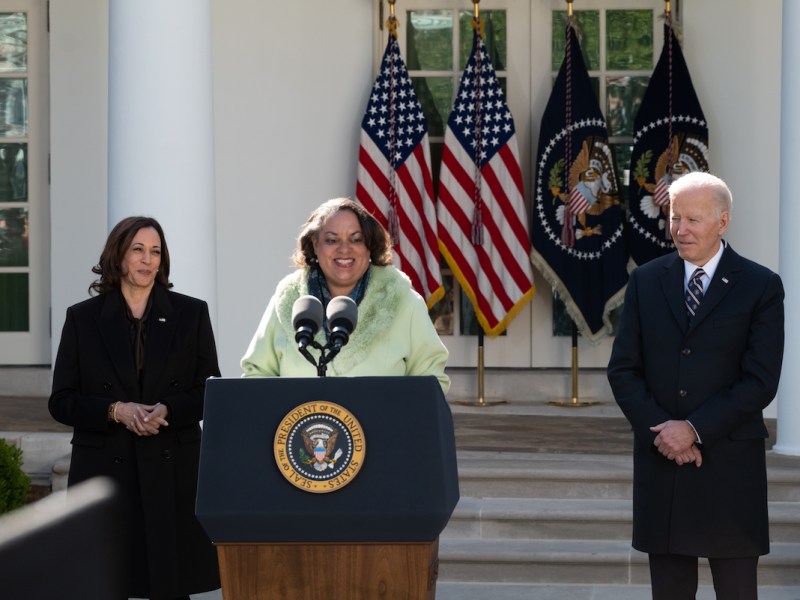 Michelle Duster, great-granddaughter of Ida B. Wells, stands with Vice President Kamala Harris (left) and President Joe Biden after Biden signed into law H.R. 55, the Emmett Till Anti-lynching Act, in the White House Rose Garden on March 29. (Cheriss May/The Washington Informer)