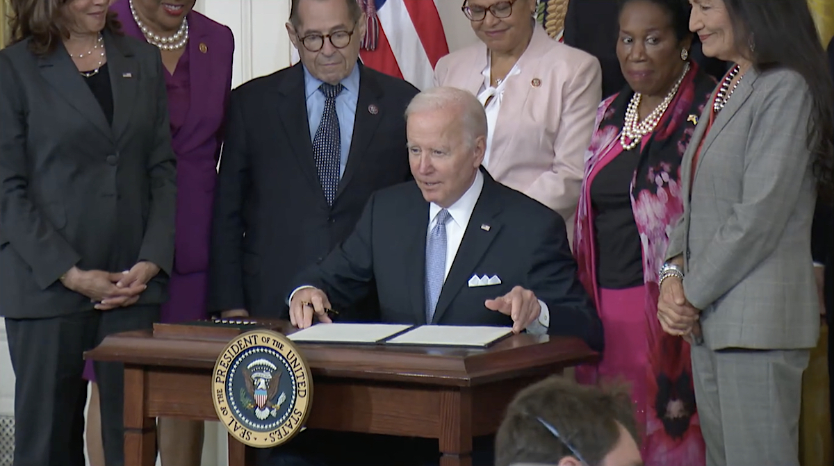 President Joe Biden signs an executive order on police reform in the East Room of the White House on May 25, 2022, the second anniversary of George Floyd's death.