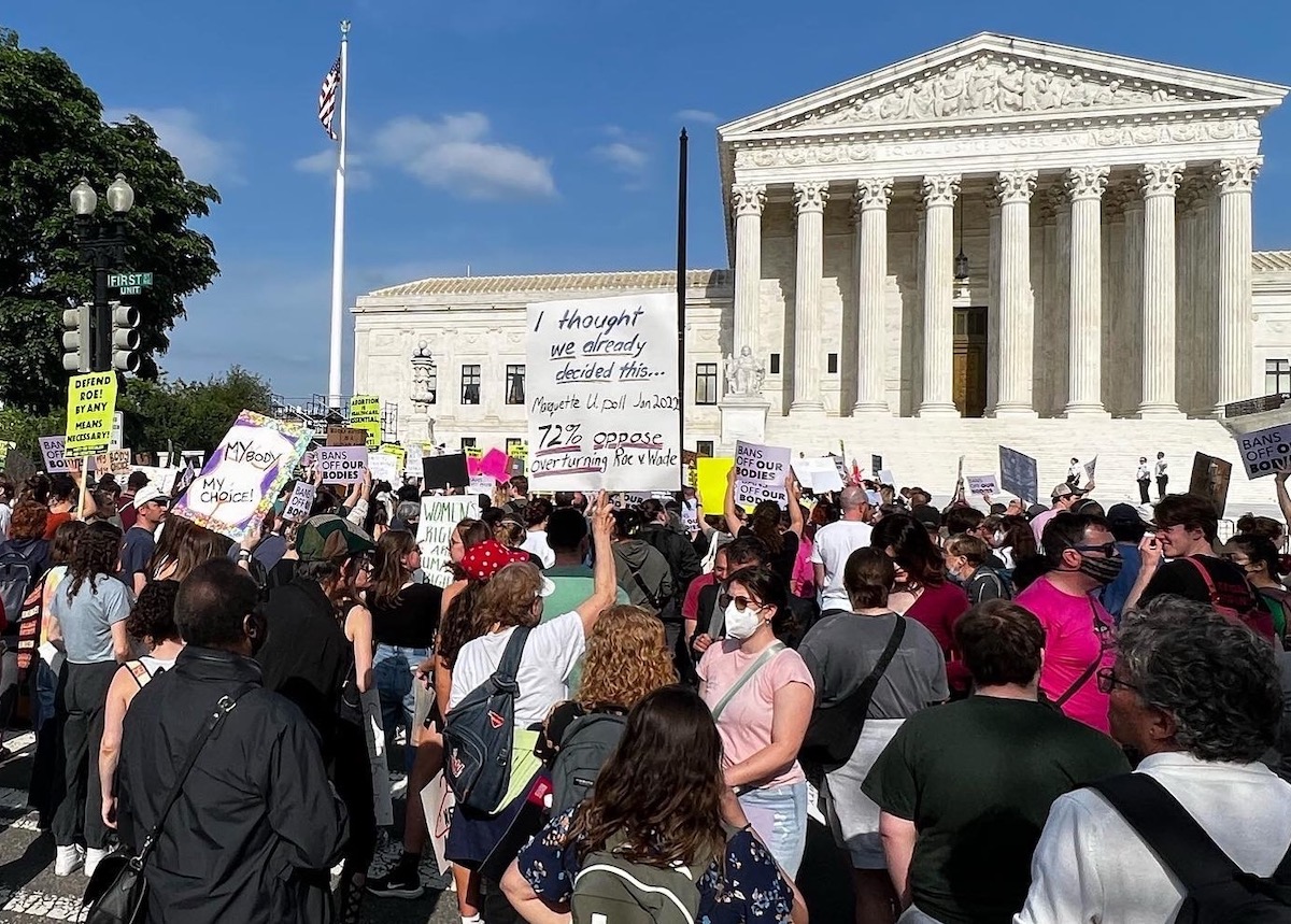 Demonstrators stand outside the Supreme Court building in D.C. on May 3 to protest the leaked abortion opinion seeking to overturn Roe v. Wade. (Anthony Tilghman/The Washington Informer)