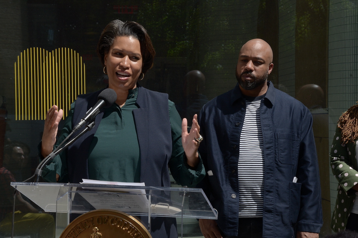 District of Columbia Mayor Muriel Bowser announces the Inclusive Innovative Equity Impact Fund grant at Manifest in northwest D.C. on May 2 as its owner KJ Hughes looks on. (Roy Lewis/The Washington Informer)