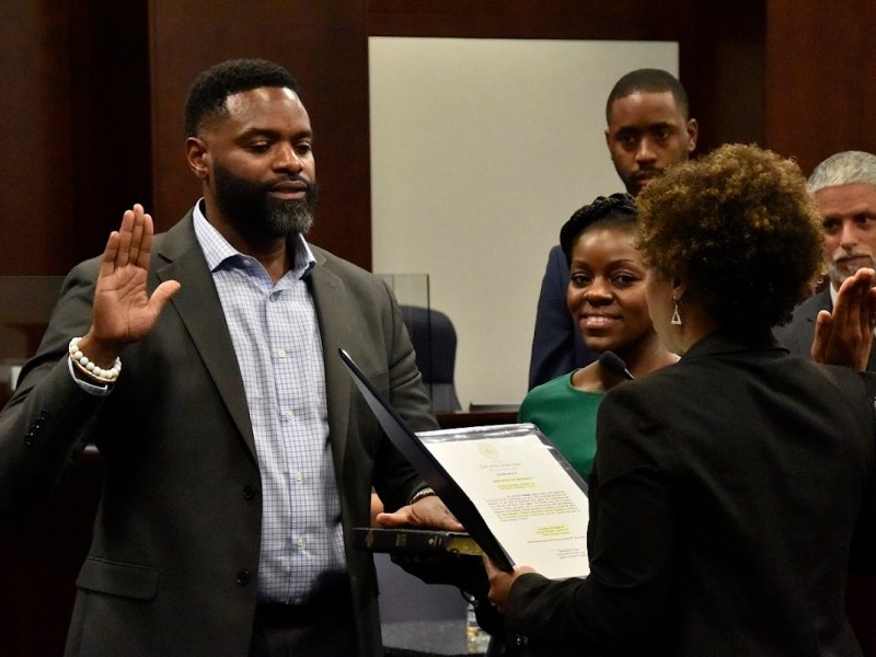 Former District Heights, Maryland, Mayor Johnathan Medlock (left) is sworn in as a interim member of the Prince George's County Council by Mahasin El Amin, clerk of the county's circuit court, during a ceremony May 9. Medlock fills vacated District 6 seat on the council until December. (Robert R. Roberts/The Washington Informer)