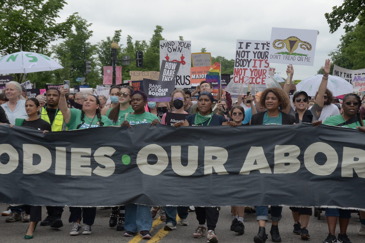 Thousands of people marched to the U.S. Supreme Court building protesting a draft of an opinion gutting Roe v. Wade. (Roy Lewis/The Washington Informer)