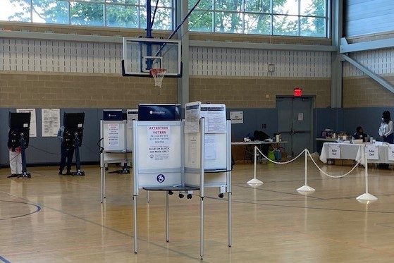 Two voters cast their ballots at the Deanwood Community Center and Library in northeast D.C. on June 21, the date of the city's primary election. (William J. Ford/The Washington Informer)