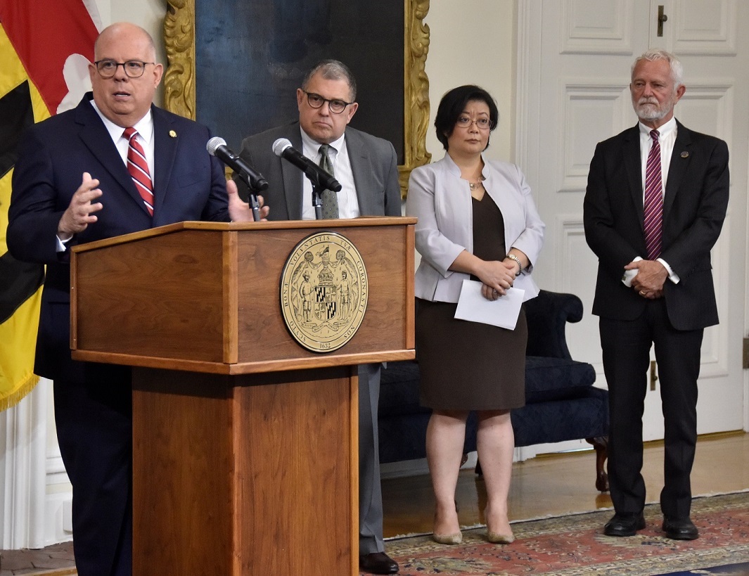 Maryland Gov. Larry Hogan (left) speaks during a June 9 press briefing to announce the state's long-term plan to battle COVID-19. Joining Hogan (from left) are state Health Secretary Dennis Schrader; Dr. Jinlene Chan, the state’s deputy health secretary for public health services; and Dr. Howard Haft, executive director of the Maryland Primary Care Program. (Robert R. Roberts/The Washington Informer)