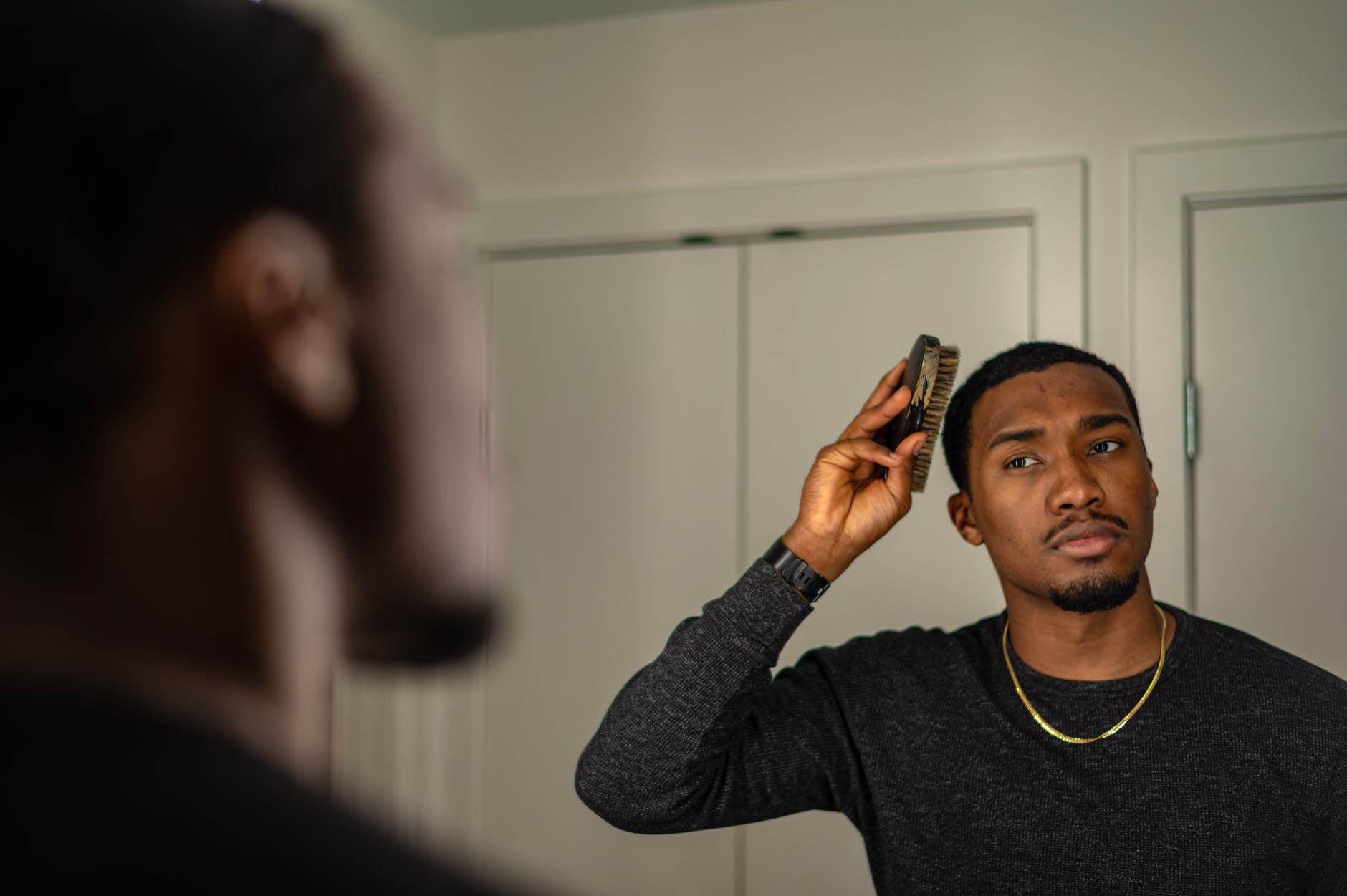 stylish man combing his hair
