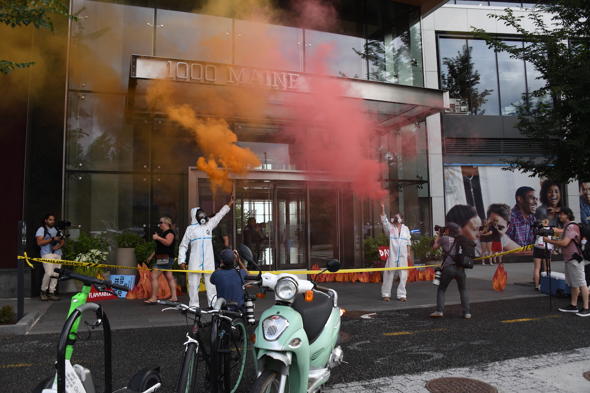 Members of Extinction Rebellion DC protest at the Washington Gas building in the Wharf in southwest D.C. to prevent planned multibillion-dollar investment in new gas pipes throughout the city. (Anthony Tilghman/The Washington Informer)