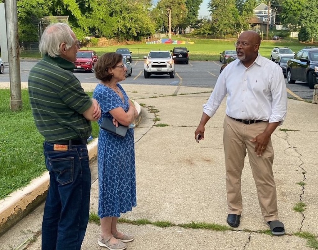 Former Prince George’s County State’s Attorney Glenn Ivey, right, chats with a couple of voters as they wait to go inside to vote July 19 at the Judith P. Hoyer Early Childhood Center in Cheverly. (William J. Ford/The Washington Informer)