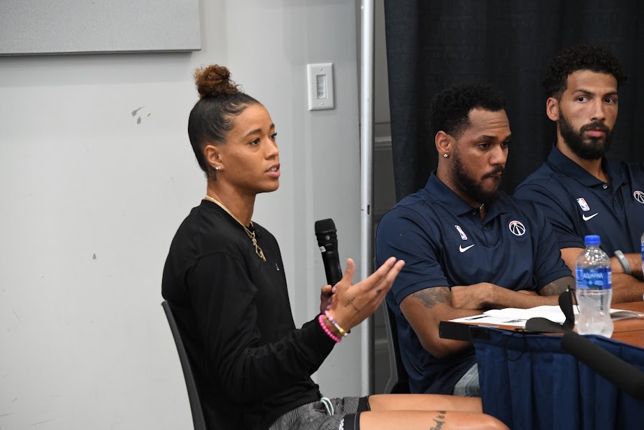 Fron left: Washington Mystics guard Natasha Cloud talks about her dedication to helping the city solve its gun violence problem while Washington Wizards players Monte Morris and Anthony Gill listen. (Anthony Tilghman/The Washington Informer)