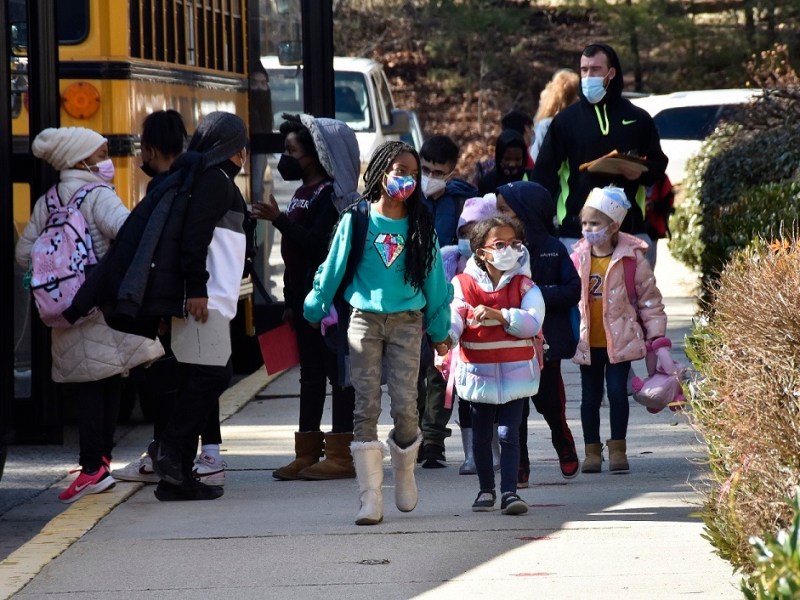 **FILE** Students at Bond Mill Elementary in Laurel walk toward a school bus after dismissal from school on Feb. 25. (Robert R. Roberts/The Washington Informer)