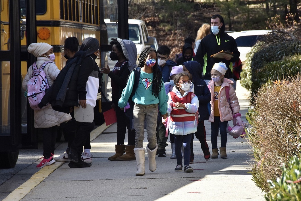 **FILE** Students at Bond Mill Elementary in Laurel walk toward a school bus after dismissal from school on Feb. 25. (Robert R. Roberts/The Washington Informer)