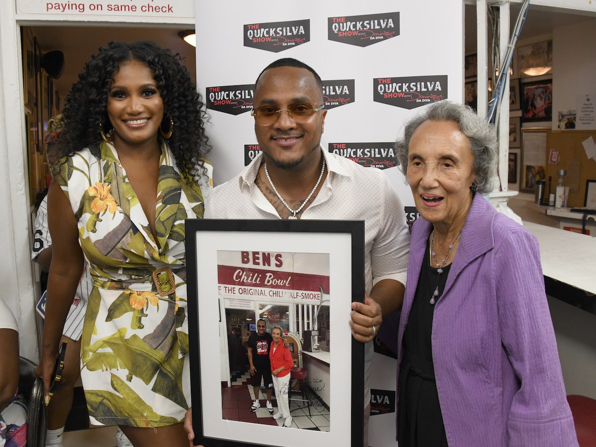 Roberto "DJ Quicksilva" Silva (center) poses with wife Ashley Silva (left) and Ben's Chili Bowl co-founder Virginia Ali at the northwest D.C. eatery after he was added to Ben's Wall of Fame on Aug. 17 (Anthony Tilghman/The Washington Informer)