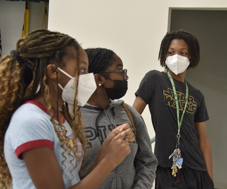 Micah Smith (right) talks with his sister, Mischa Smith (left) and Camryn Kelly at a social justice camp at the Spauldings Branch library in District Heights, Maryland, on Aug. 3. (Robert R. Roberts/The Washington Informer)