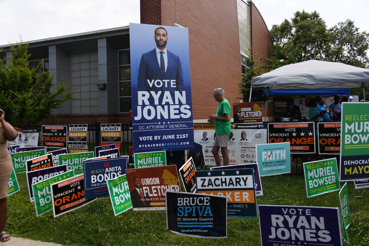 Campaign signs from the recent primaries remain posted throughout D.C., despite a city ordinance that requires their removal no later than 30 days after the elections. (Anthony Tilghman/The Washington Informer)