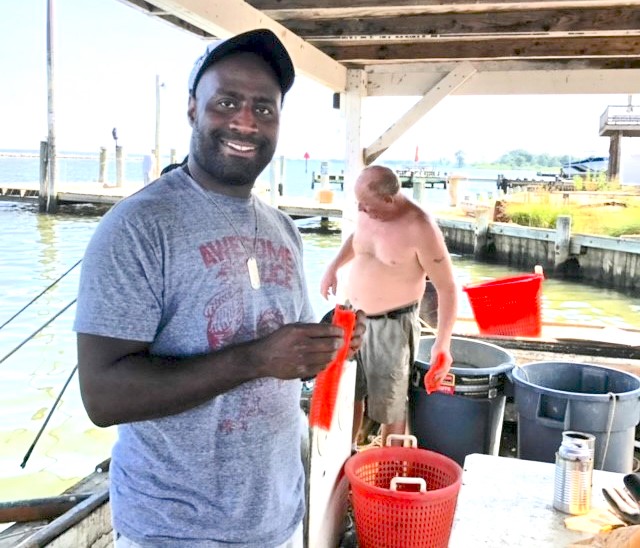 Ronald L. Williams shows off his crabbing efforts on Maryland’s Eastern Shore. (Courtesy photo)