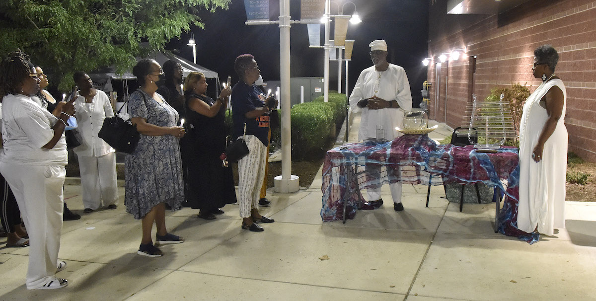 Saleem and Ivy Hilton perform a libation ceremony for those who have died from drug overdoses. (Robert R. Roberts/The Washington Informer)