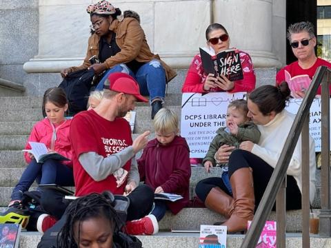 School librarians, parents and students armed with their favorite books participate in a public “read-in” at the Wilson Building in northwest D.C. on Oct. 22. (Photo courtesy of K.C. Boyd)