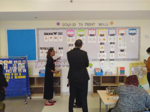 Elizabeth Corney (left), an English and Language Arts instructional coach at Stanton Elementary School in Southeast, and DCPS Chancellor Lewis Ferebee look at a sound-to-print wall that displays unique movements of lips and tongues for vowel and consonant sounds. (Sam P.K. Collins/The Washington Informer)