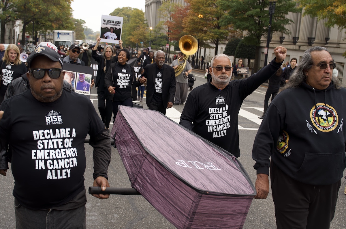 Demonstrators hold a casket symbolic of all the lives lost in their community due to environmental racism. The rally started at Freedom Plaza and headed to the White House part of the People vs. Fossil Fuels Campaign on Oct. 25, demanding a cessation of fossil fuel projects. (Marckell Williams/The Washington Informer)
