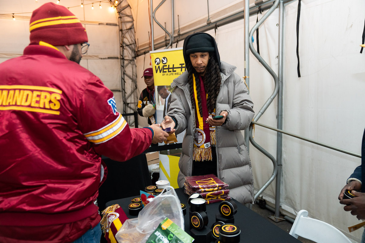 Entrepreneur Desmond Barnes, co-founder of Heart of the City, a candle company during, the Shop Black Holiday Market during the Washington Commanders game on Dec. 18 (Abdullah Konte/The Washington Informer)