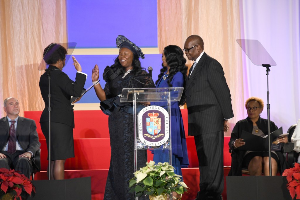 Prince George’s County Council member Krystal Oriadha (second from left) is sworn in on Dec. 5 during a ceremony at Show Place Arena in Upper Marlboro, Maryland, as her family joins her on stage. (Anthony Tilghman/The Washington Informer)