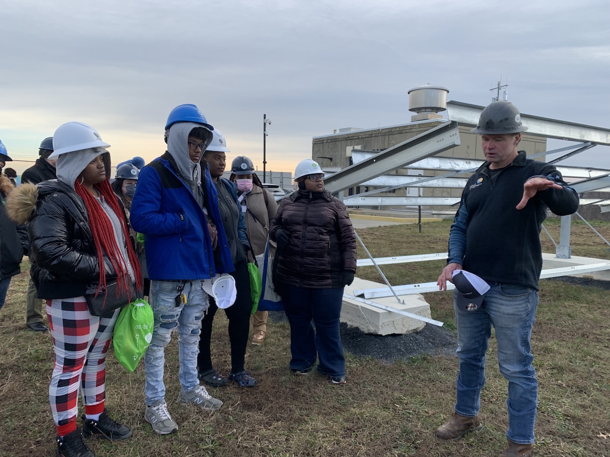 Students from KIPP DC College Prep tour a solar facility and speak with leaders involved in the project's construction on Dec. 19. (Kayla Benjamin/The Washington Informer)