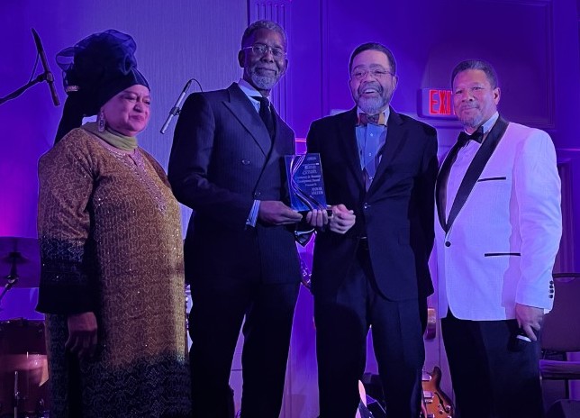 Anwar Saleem (third from right) receives an award from Muslim Journal Internation- al Editor Ayesha K. Mustafaa, Anwar, program host Ibrahim Mumin and Masjid Muhammad Imam Talib M. Shareef. (D.R. Barnes/The Washington Informer)