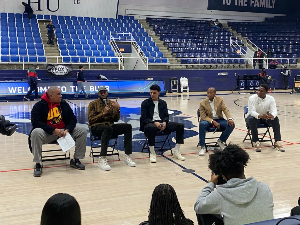 A professional panel of NBA players, including the Golden State Warriors' Andre Iguodala, who is holding the microphone, speaks to Howard students as part of the Wizards/Warriors Networking Opportunity. (Jazmyn Hammons/Howard University)