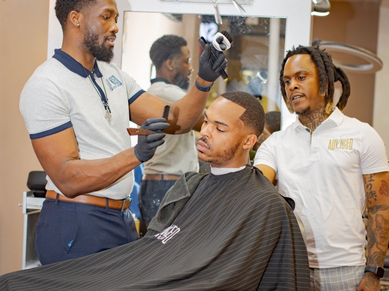 Le'Vance Bell is the owner of Advanced Grooming located in the Fashion Centre at Pentagon City Mall in Arlington, Virginia, cuts the hair of Jerry Carter.