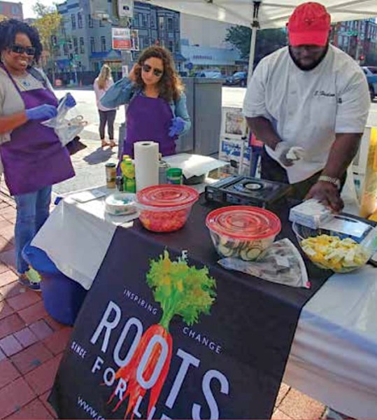 Roots for Life Executive Director Rhonda Watson and volunteers preparing to cook at the Markets & More Farmers' Market.