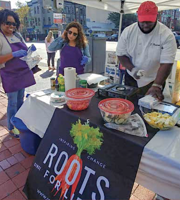 Roots for Life Executive Director Rhonda Watson and volunteers preparing to cook at the Markets & More Farmers' Market.